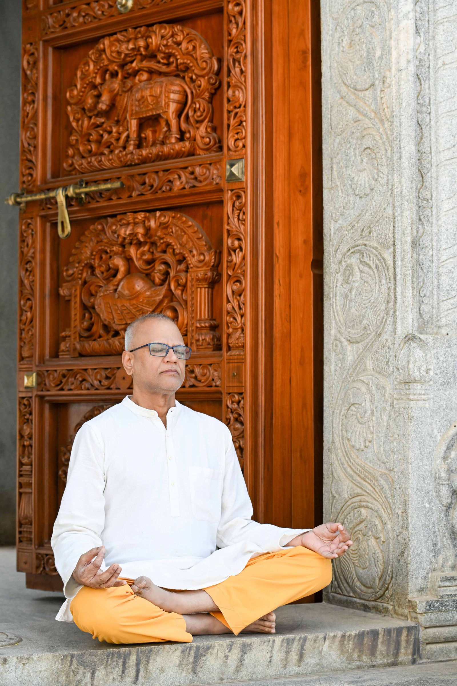Rajesh Anand meditating in a temple doorway