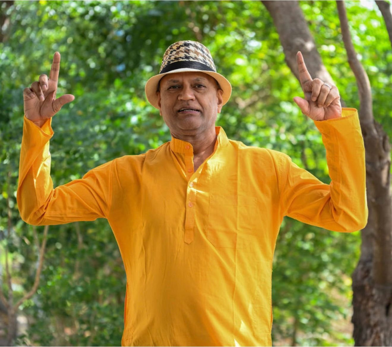 Rajesh Anand speaking beneath the trees